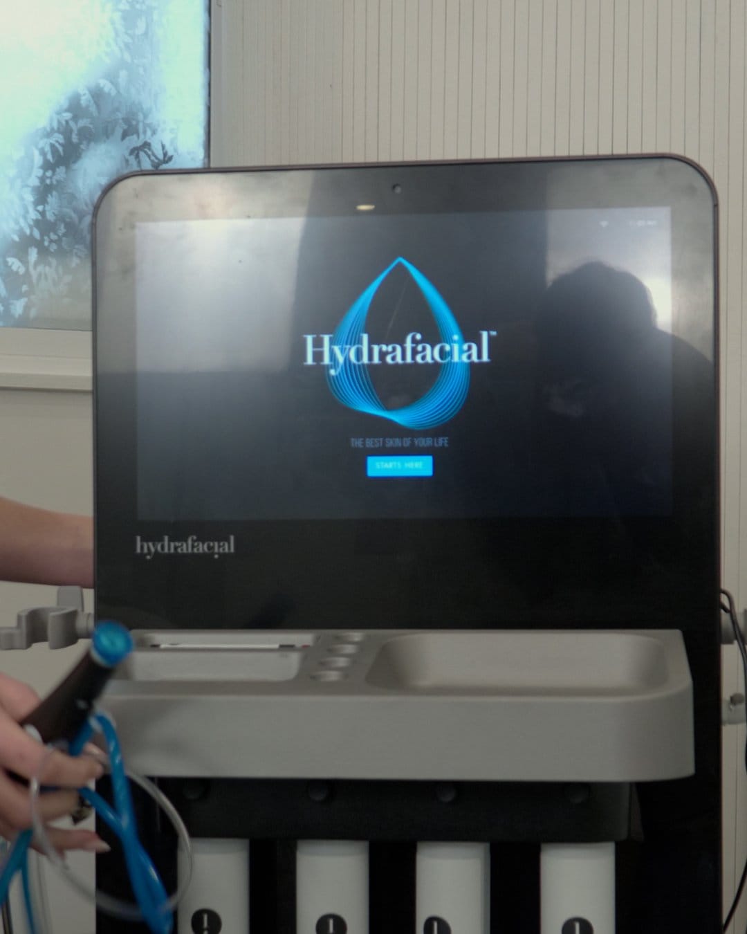 A Hydrafacial machine in the clinic with its touchscreen switched on
