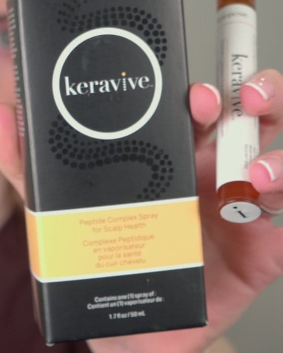 A box of scalp-care product held up to the camera